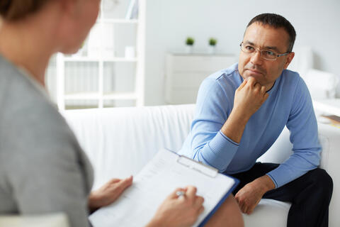Adult on a sofa listens to a psychologist